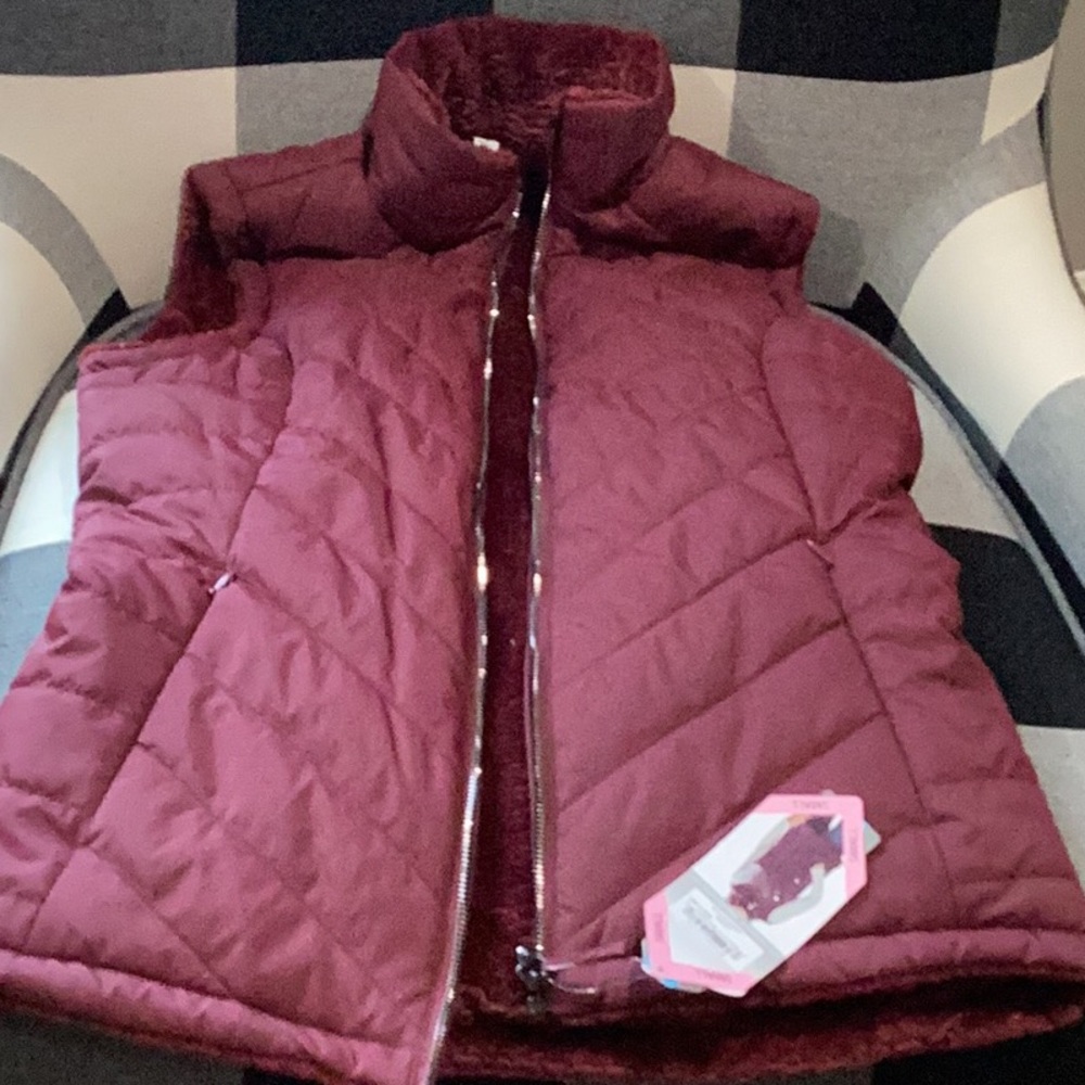 Maroon vest with fuzzy inside, adult small brand new with tags